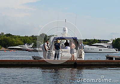 Inspector of the state Inspectorate for small vessels checks the crew of the motor yacht in the waters of the Khimki reservoir in Editorial Stock Photo