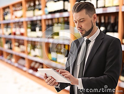 Inspector with tablet in supermarket. Quality control Stock Photo