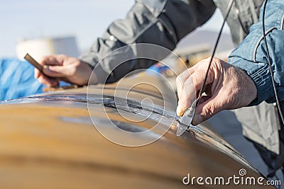 Inspector is ultrasonic testing to pipe welds. Ultrasonic Testing UT uses high frequency sound waves. Stock Photo