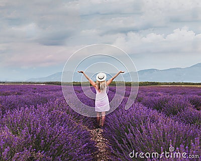 Inspiration and creativity concept, woman in inspiring landscape of lavender blooming field Stock Photo