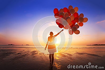 Inspiration, joy and happiness concept, silhouette of woman with many flying balloons Stock Photo