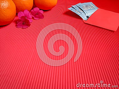 inspirational chinese new year concept image of red envelope,money,oranges and flowers in red colour background Stock Photo