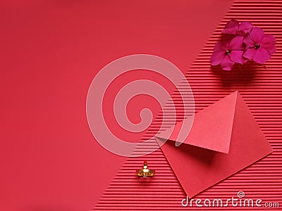 inspirational image of red envelope, golden rings and flower in red colour background Stock Photo