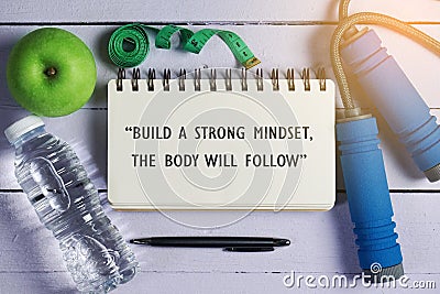 Inspirational motivating quote on notebook. Build a strong mindset, the body will follow. Stock Photo
