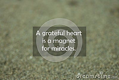 Inspirational motivational quote - A grateful heart is a magnet for miracles. With blurry black sands pattern texture background. Stock Photo