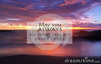 Inspirational motivational quote- May you always do what you are afraid to do. With blurry image of dramatic colorful sky at Stock Photo