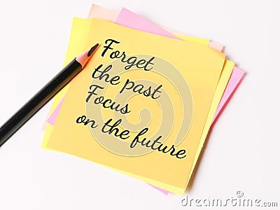 Phrase forget the past focus on the future written on sticky note with a pencil. Stock Photo