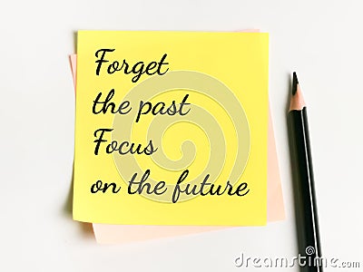 Phrase forget the past focus on the future written on sticky note with a pencil. Stock Photo
