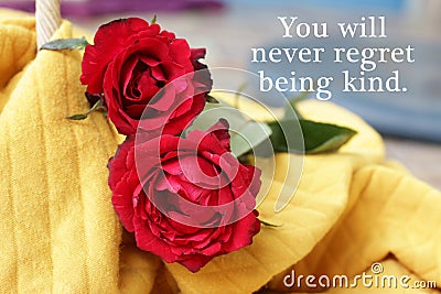 Inspirational motivational quote - You will never regret being kind. Kindness concept with red roses lying on yellow background. Stock Photo