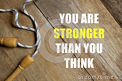 Inspirational motivational quotes You Are Stronger Than You Think on wooden background. Health and fitness concept. Stock Photo