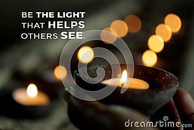 Inspirational quote - Be the light that helps others see. Be inspire and kindness concept with person holding a candle light. Stock Photo