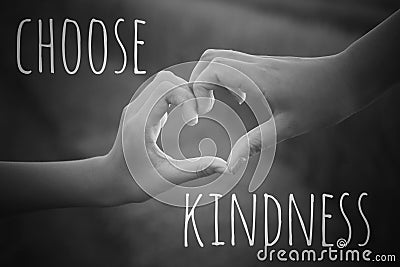 Inspirational quote - Choose kindness. With hands making love sign on black and white background. Being kind concept. Stock Photo