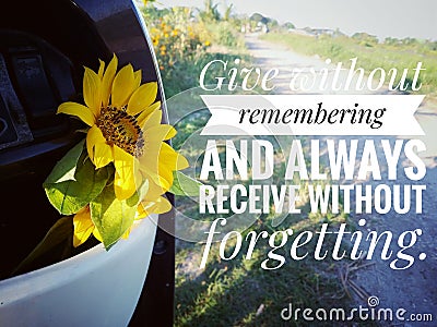 Inspirational quote - Give without remembering and always receive without forgetting. with yellow sunflower flower in bike drawer. Stock Photo