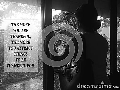 Inspirational quote - The more you thankful the more you attract things to be thankful for. Young woman and sign on window Stock Photo