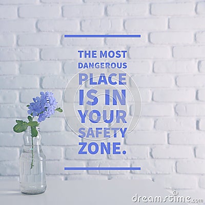 Inspirational quote `The most dangerous place is in your safety zone` Stock Photo