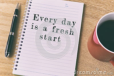 Inspirational quote on notepad - Every day is a fresh start Stock Photo