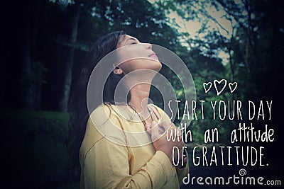 Inspirational quote - Start your day with an attitude of gratitude. Woman in the park with hands on chest. Stock Photo