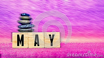 inspirational time concept - word may on wooden blocks with stack of pebbles in purple vintage background Stock Photo