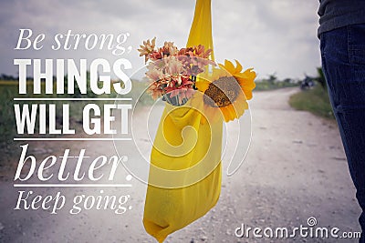 Inspirational words - Be strong. Things will get better. Keep going. Young man or woman with bouquet of flowers in yellow eco bag. Stock Photo