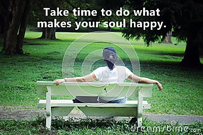 Inspirational words - Take time to do what makes your soul happy. Happiness quote concept with young woman sitting on a bench. Stock Photo