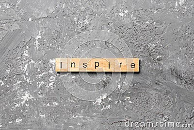 Inspire word written on wood block. Inspire text on cement table for your desing, concept Stock Photo