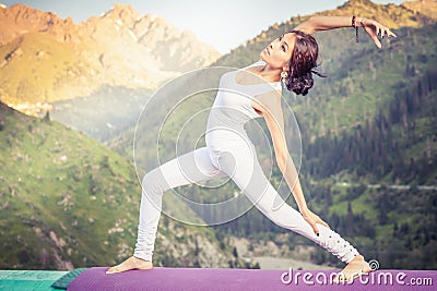 Inspired asian woman doing exercise of yoga at mountain range Stock Photo
