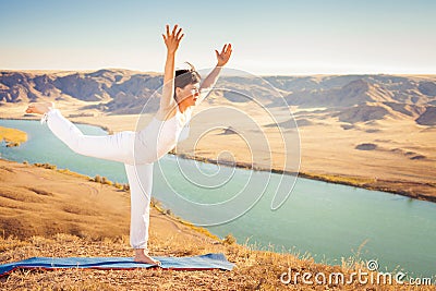 Inspired asian woman doing exercise of yoga at mountain range Stock Photo