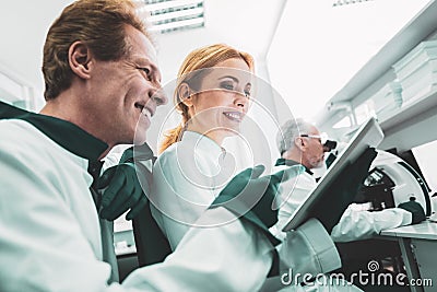 Inspired biologist showing work photos to his colleague Stock Photo