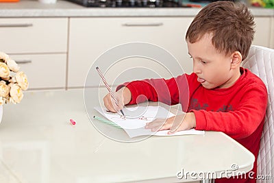 Inspired by the boy draws a picture on the paper at the table Stock Photo