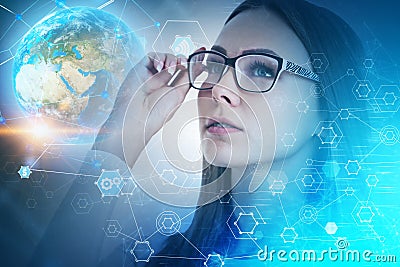 Inspired businesswoman looking at global network Stock Photo