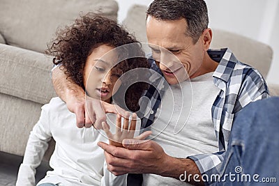Inspired father teaching his daughter to count on her fingers Stock Photo
