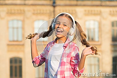 Inspired by favorite song. small girl listen to music. kid in headphones. childhood happiness. happy child in playful Stock Photo