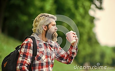Inspired handsome hipster. Drink tea or coffee. Man with cup outdoors. Man outdoors with cup of coffee. Drinking hot Stock Photo