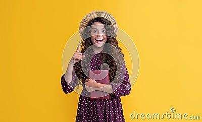 inspired with idea kid with frizz hair hold book on yellow background Stock Photo