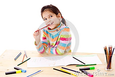 Inspired little girl draw with crayons Stock Photo