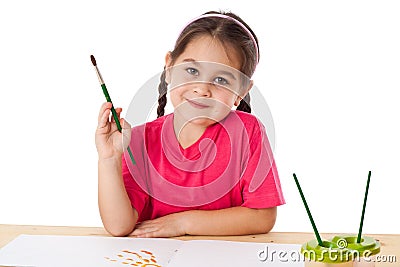 Inspired little girl with paintbrush Stock Photo