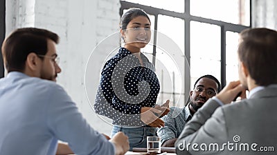 Confident indian businesswoman convincing thoughtful multiethnic business partners on negotiations Stock Photo