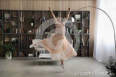 Inspired teen indian lady dance ballet at large modern apartment Stock Photo