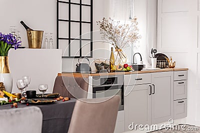 Inspiring kitchen and dining room interior idea with white kitchen furniture Stock Photo