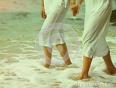 Instagram colorized vintage couple at beach legs portrait Stock Photo