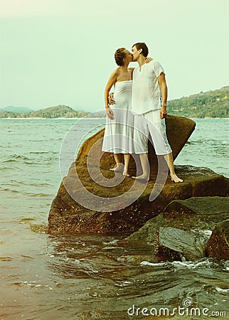 Instagram colorized vintage couple on beach portrait Stock Photo