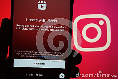 Instagram Reels start screen seen on mobile phone and Instagram logo on blurred background. New feature from Facebook aimed to cre Editorial Stock Photo