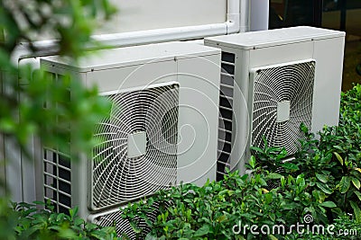 Install air conditioning in tall buildings surrounded by trees Stock Photo