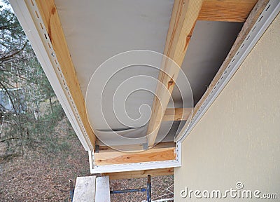 Install Soffit. Roofing Construction. Soffit and Fascia is Usually Constructed of Vinyl, Wood or Aluminum. Stock Photo