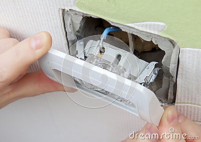 Install wall light switch Insert into electrical box Stock Photo