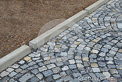 Installation of concrete curbs with gaps that let water into the park into the ditch, where it seeps into the grass and does not d Stock Photo