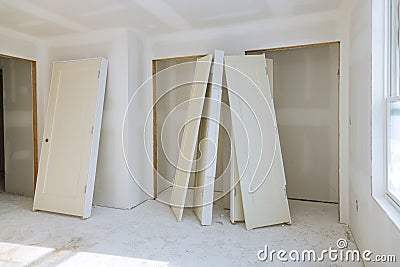 Installation for construction of housing waiting at interior wood door Stock Photo