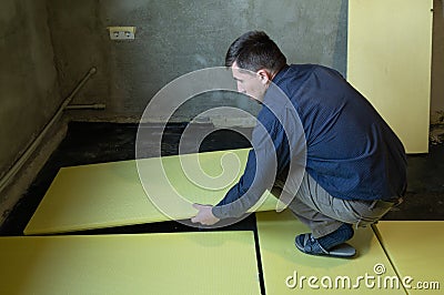 Installation of expanded polystyrene for floor insulation. Stock Photo