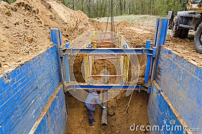 Installation of metal supports to protect the walls of the trench. Stock Photo