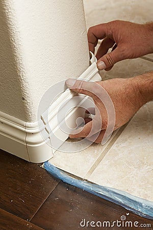 Installation of New Baseboard & Bull Nose Cornerns Stock Photo